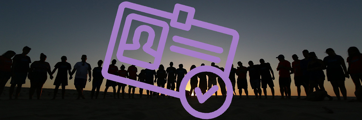 group of people with joined hands, sunset background